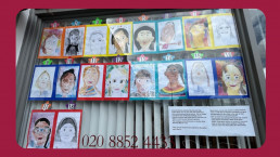 A collection of colorful children's drawings of faces displayed in a window, each marked with a number, showcasing the creativity and diversity of young artists.